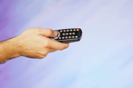 Close_up of a manŽs hand holding a remote control