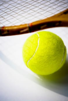 Close_up of a tennis racket and a tennis ball
