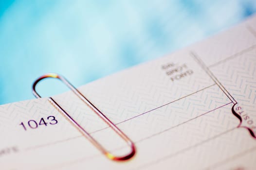 Close_up of a check with a paper clip