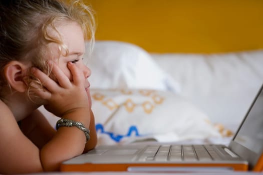 Baby girl looking at a laptop