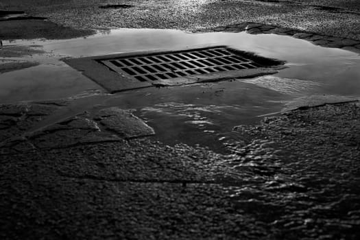High angle view of a sewer drain after rain