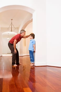 Man measuring his sonŽs height