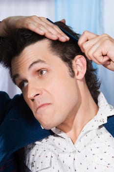 Man combing his hair
