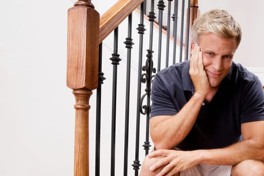 Man sitting on a staircase and smiling