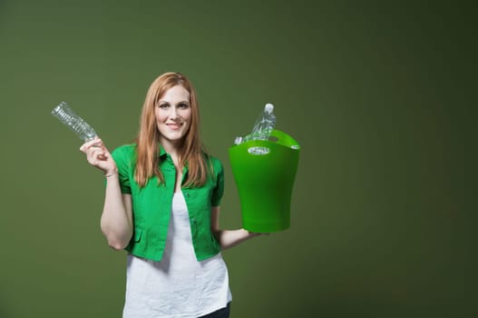 Portrait of a woman holding a recycling bin