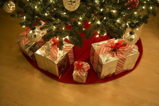 High angle view of Christmas presents under a Christmas tree
