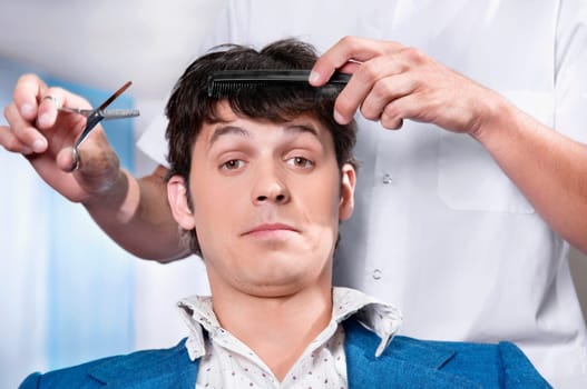 Man receiving a haircut in a salon