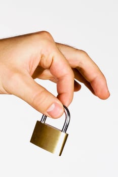 Close_up of a manŽs hand holding a padlock