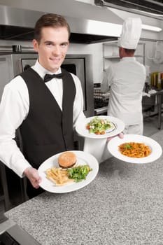 Waiter holding plates of foods