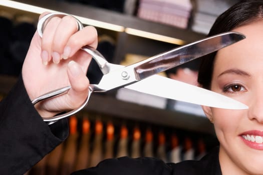 Portrait of a female tailor holding scissors