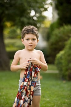 Portrait of a boy holding a towel