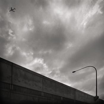 Low angle view of an airplane flying in the cloudy sky