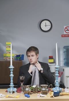 Businessman adjusting napkin in lunch break