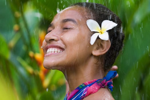 Close_up of a teenage girl enjoying rain shower
