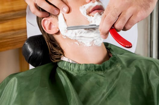 Man getting shaved in a salon