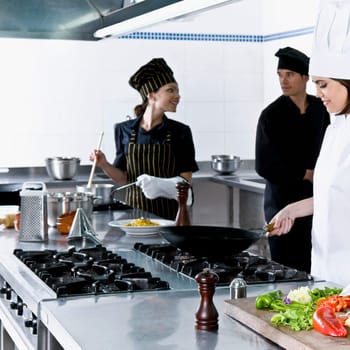 Chefs cooking food in the kitchen