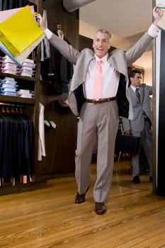Businessman holding shopping bags in a clothing store