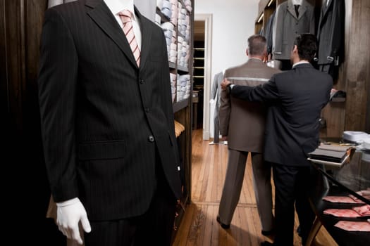 Tailor taking the measurements of a customer