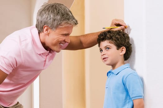 Man measuring his sonŽs height
