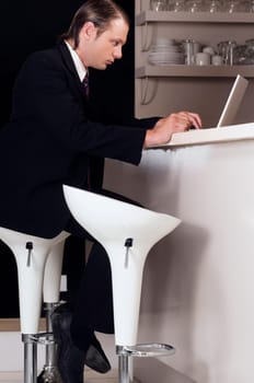 Businessman working on a laptop in a bar