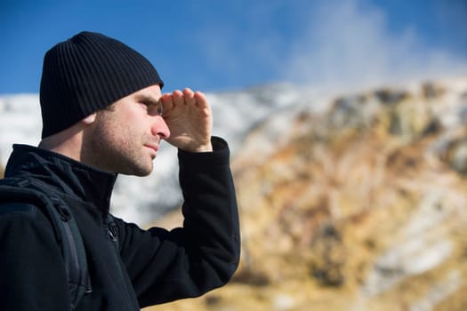 Man shielding his eyes, Mammoth Hot Springs, Yellowstone National Park, Wyoming, USA