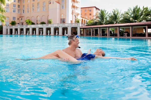 Couple romancing in a swimming pool, Biltmore Hotel, Coral Gables, Florida, USA