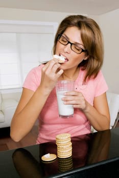Woman having cookies and milk