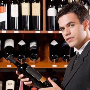 Businessman holding a wine bottle