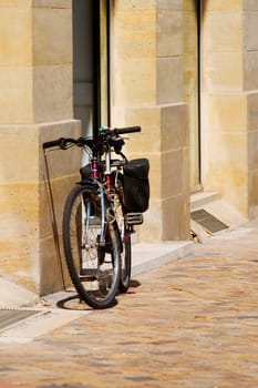 Bicycle parked against a wall