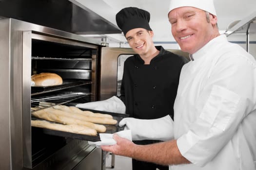 Two chefs preparing food in the kitchen