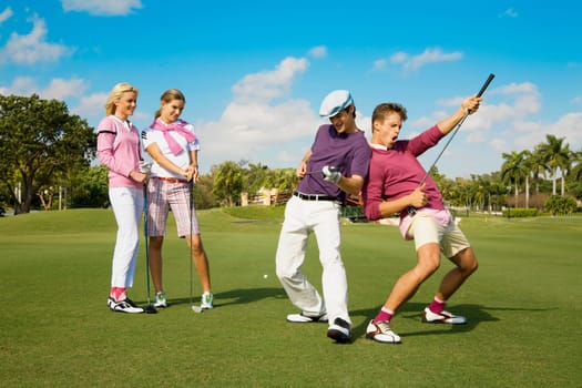 Four friends having fun in a golf course, Biltmore Golf Course, Coral Gables, Florida, USA