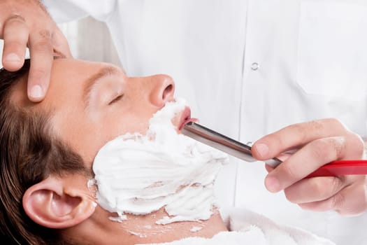 Man getting shaved in a salon