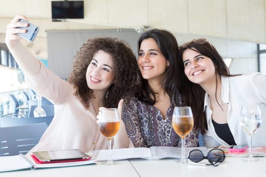 Group of happy students preparing their exams or simply relaxing at a bar