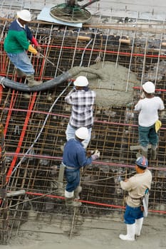 High angle view of five construction workers working at a construction site