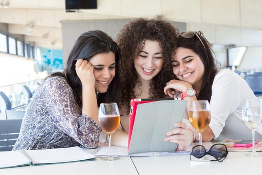 Group of happy students preparing their exams or simply relaxing at a bar