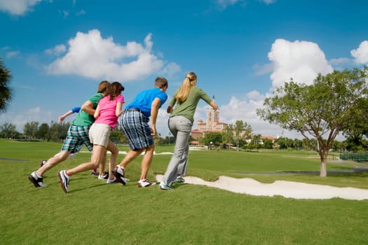 Five friends having fun in a golf course, Biltmore Golf Course, Coral Gables, Florida, USA