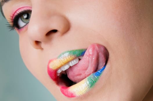 Portrait of a young woman licking her lips