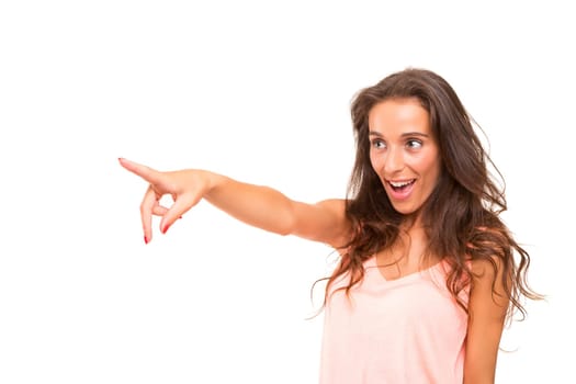 A beautiful woman pointing to something, isolated over a white background