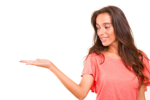 Young beautiful woman presenting your product, isolated over white background