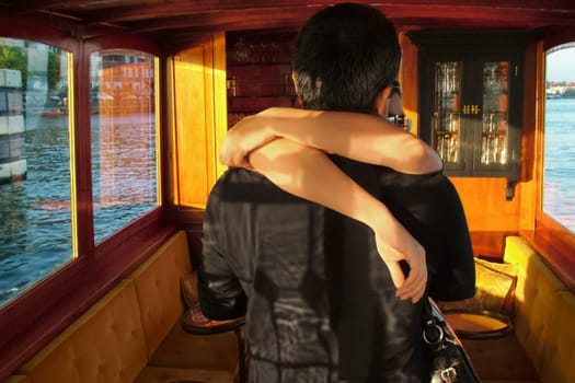 Close_up of a couple embracing each other in a tourboat