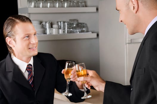Two businessmen toasting with wine in a bar