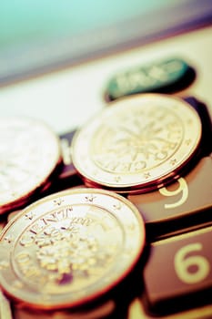 Close_up of European union coins on a calculator