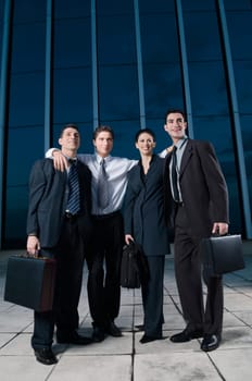 Four business executives smiling together