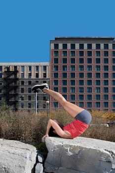 Woman exercising on a stone