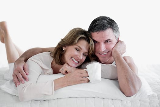 Couple lying on the bed and smiling