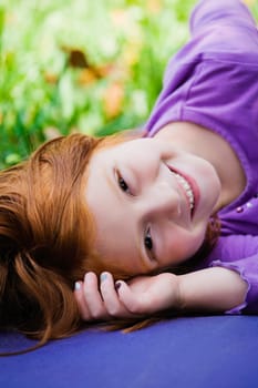 Portrait of a girl lying down and smiling