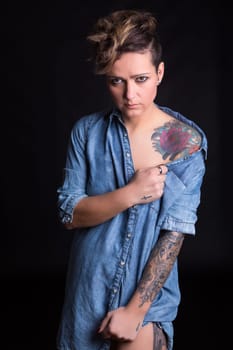 Studio shot of a young tattooed woman