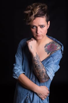 Studio shot of a young tattooed woman