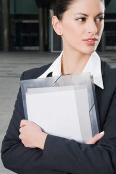 Close_up of a businesswoman holding files