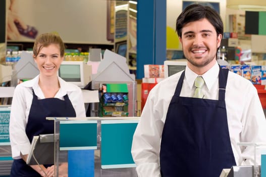 Sales clerks smiling in a supermarket